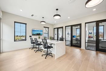 A conference room with a long table and chairs.at The Garrison Luxury Apartment Homes, Fountain, 80817